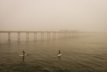 Paddling By The Pier is a photograph by T.M. Schultze taken at San Diego, California