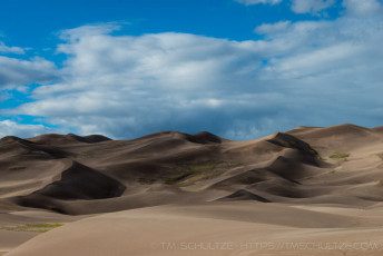 is a photograph by T.M. Schultze taken at Great Sand Dunes National Park, Colorado