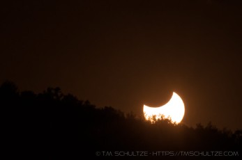Solar Eclipse Sunset is a photograph by T.M. Schultze taken 2012 at Descanso, California