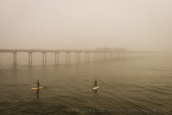 Paddling By The Pier is a photograph by T.M. Schultze taken at San Diego, California