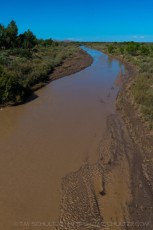 Puerco River Flows is a photograph by T.M. Schultze taken at Petrified Forest National Park, Arizona